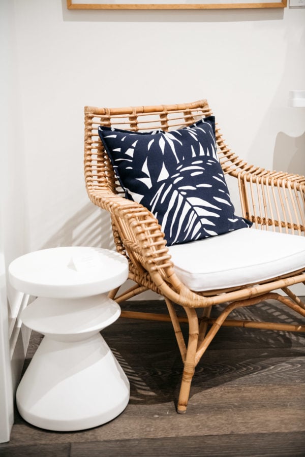 Serena & Lily Rattan Chair with blue and white printed pillows.