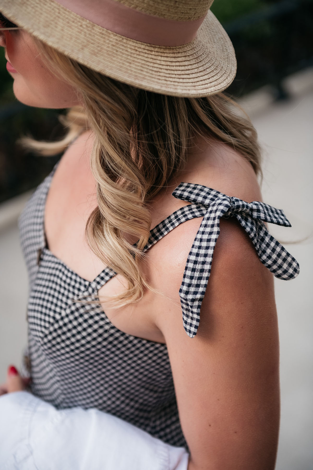 Preppy lifestyle blogger Jessica Sturdy of Bows & Sequins wearing a gingham dress with bow-tied straps.