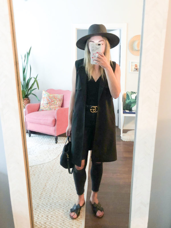 Fashion blogger Jessica Sturdy of Bows & Sequins wearing a sleeveless trench coat with a Janessa Leone hat and a Gucci belt.