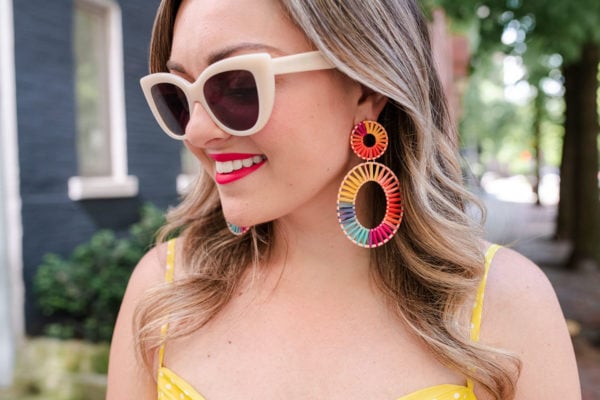 Fashion blogger Bows & Sequins styling BaubleBar rainbow raffia earrings with neutral sunglasses by Boden.