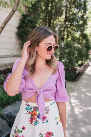 Fashion blogger styling a Rocky Barnes Express crop top with a floral skirt.