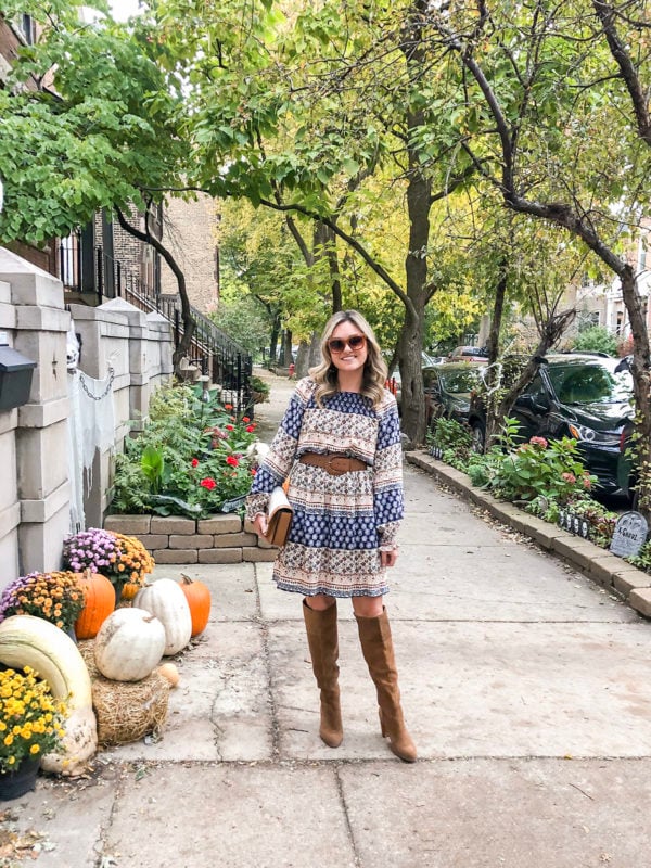Chicago blogger Jessica Sturdy of Bows & Sequins wearing a printed orange and blue dress with tan suede knee high boots.
