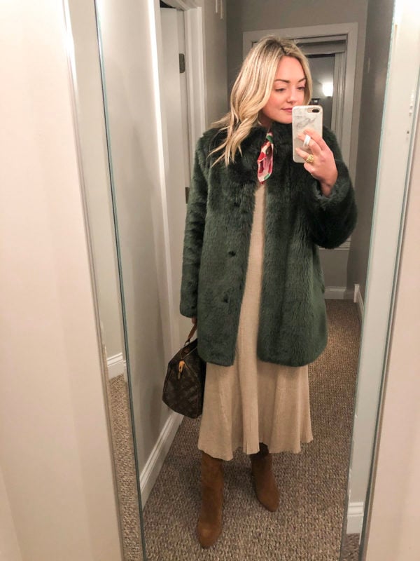 Chicago blogger Bows & Sequins styling a green faux fur coat over a ribbed sweater dress with a neck scarf and suede boots.