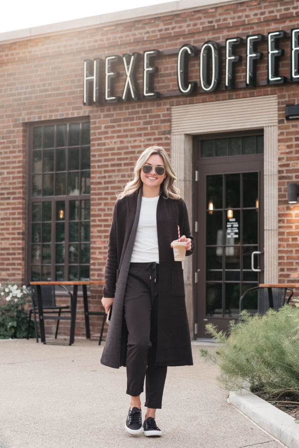 Chicago lifestyle influencer Jessica Sturdy of Bows & Sequins wearing women's jogger pants, Superga sneakers, and a Calia by Carrie Underwood long duster cardigan at Hexe Coffee.