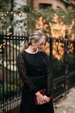 Fashion blogger Bows & Sequins wearing a classy leopard print dress with crystal statement earrings.