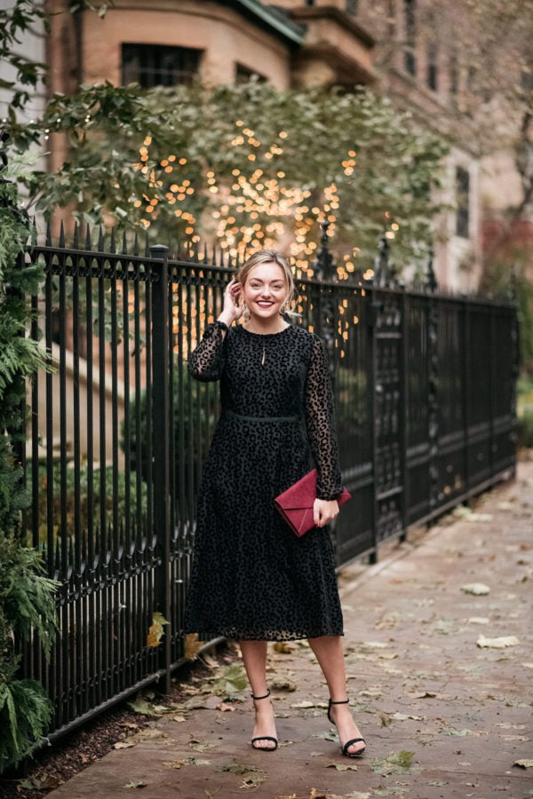 Fashion and beauty blogger Bows & Sequins styling a classic black dress for a holiday party.