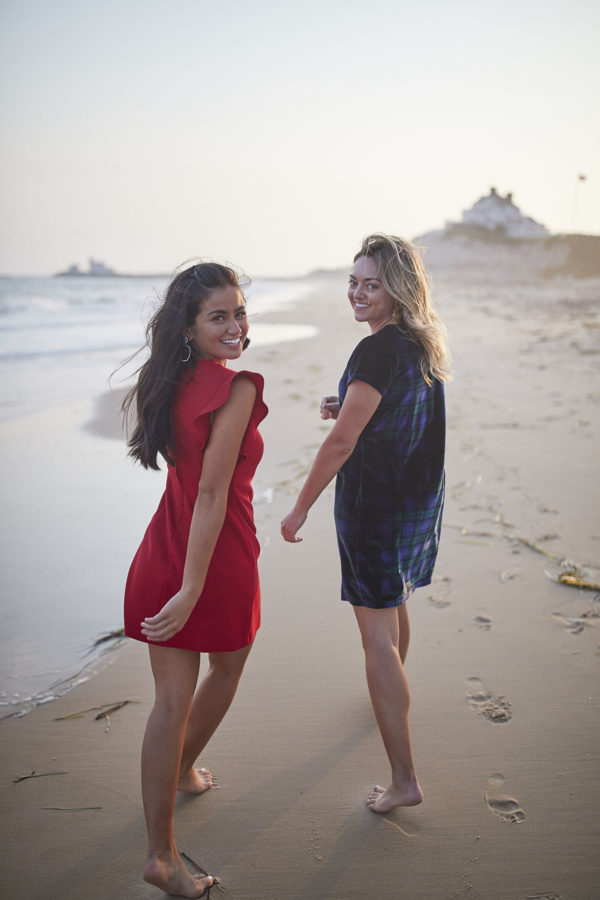 Bloggers Caila Quinn and Jessica Sturdy on the beach at sunset wearing Vineyard Vines holiday dresses.