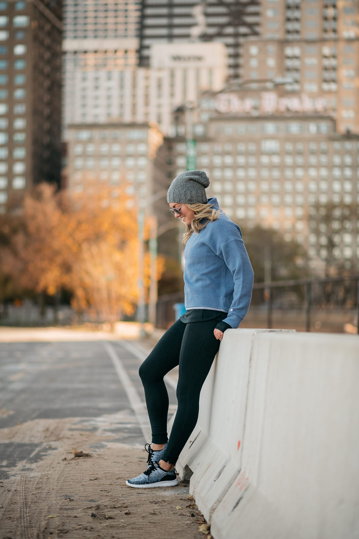 Chicago fitness blogger wearing Calia by Carrie Underwood workout clothing on the Lakefront Running Trail with the Drake Hotel in the background talking about health and wellness over the holidays.