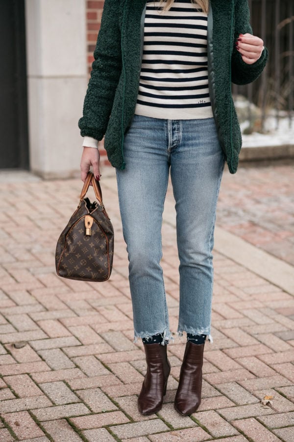 Fashion blogger wearing a striped sweater, green teddy jacket, Citizens of Humanity Charlotte jeans, and brown croc ankle booties with a Louis Vuitton Speedy bag.