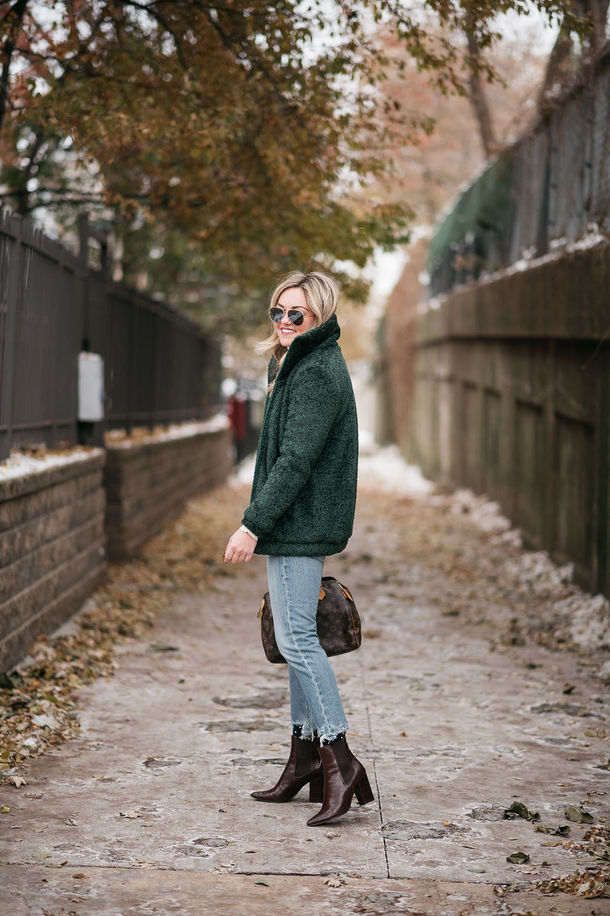 Chicago lifestyle influencer Jessica Sturdy wearing the Dudley Stephens Brooklyn Bomber with cropped jeans and brown ankle booties.
