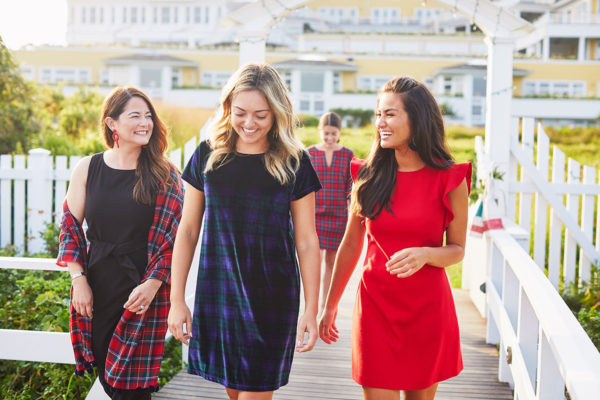 Jenn Lake, Jessica Sturdy, and Calia Quinn wearing festive holiday dresses from Vineyard Vines on the boardwalk at Ocean House Rhode Island.