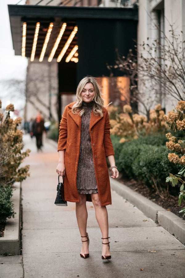 Chicago fashion influencer Bows & Sequins wearing a burnt orange teddy coat with a sparkly dress and copper pumps.