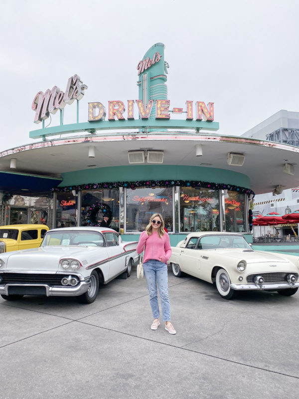 Travel blogger Bows & Sequins in front of Mel's Drive In at Universal Orlando