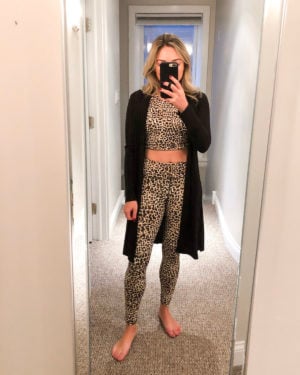 Chicago fitness blogger wearing a leopard print workout crop top and high waisted leggings set from Outdoor Voices with a black ribbed long duster cardigan.