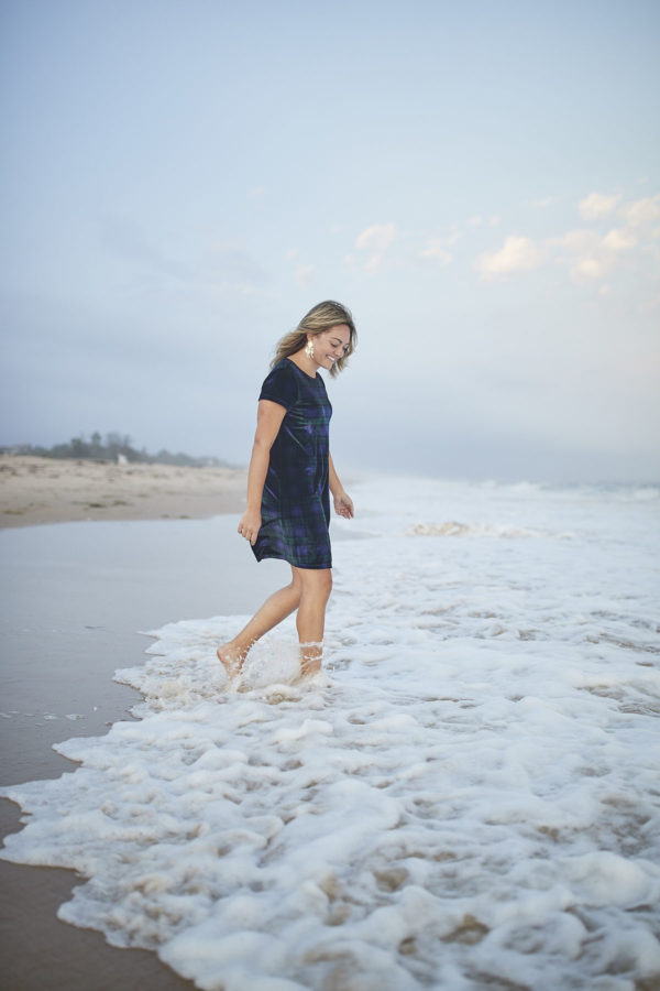 Pretty fashion blogger Bows & Sequins wearing a Vineyard Vines Plaid Velvet Dress in the ocean.