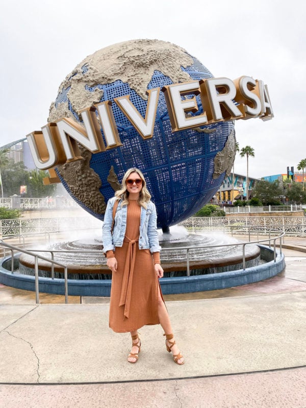 Travel blogger Jessica Sturdy of Bows & Sequins styling a Topshop Tie-Front Midi Dress with cognac suede sandals, Quay sunglasses, and a denim jacket.