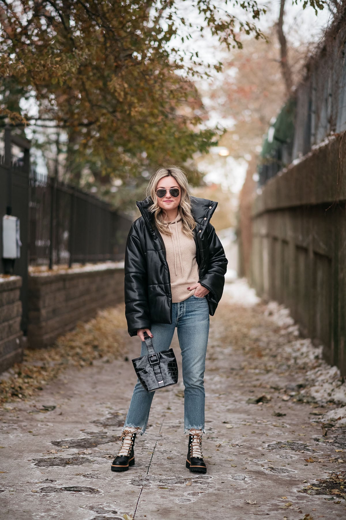 Chicago fashion blogger wearing Nanushka Puffer Coat, Vineyard Vines Hoodie, Citizens of Humanity Charlotte Crop Jeans, Marc Fisher Shearling Booties, and Brahmin Faith Bag.
