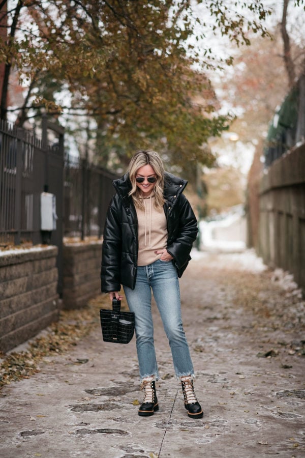 Chicago style influencer Jessica Sturdy of the lifestyle blog Bows & Sequins wearing leather puffer coat outfit with cropped jeans and shearling booties.