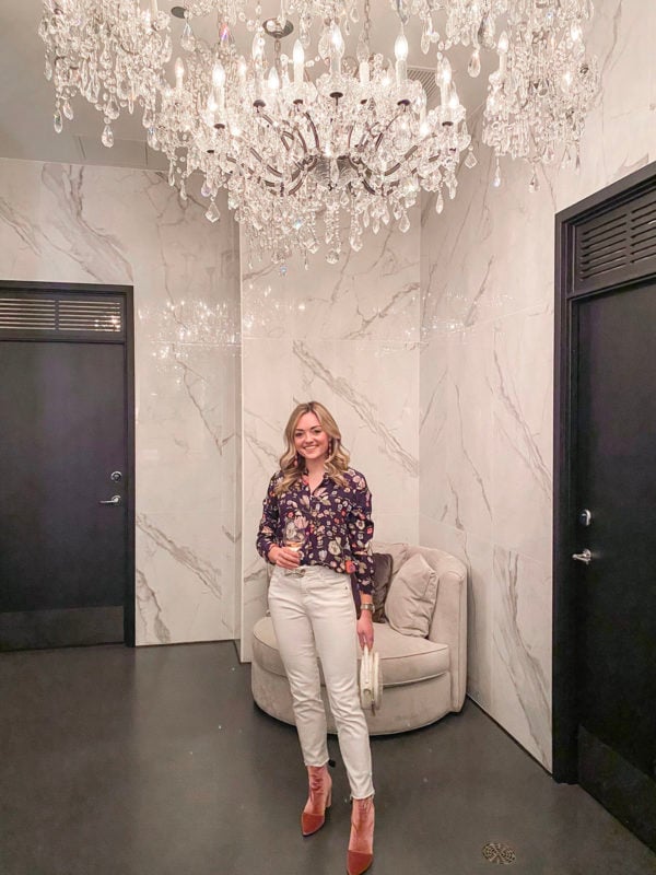 Fashion blogger wearing Rebecca Taylor floral silk blouse, Vineyard Vines white jeans, Roger Clergerie pink velvet booties, and Brahmin round handbag at The Dalcy in Chicago.