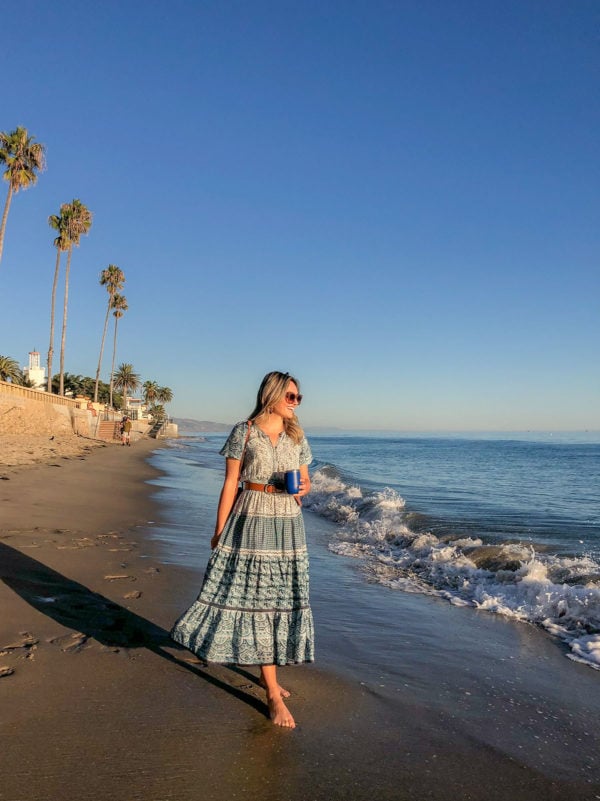 Jessica Sturdy wearing a blue printed Sea New York dress on Butterfly Beach in Santa Barbara, California at sunset.