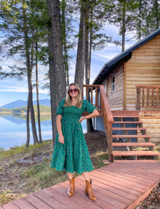 Top lifestyle blogger Jessica Sturdy wearing a Hill House Nap Dress in the Green Trellis Print with Alvies Cowboy Boots for Women at a VRBO cabin in Montana.