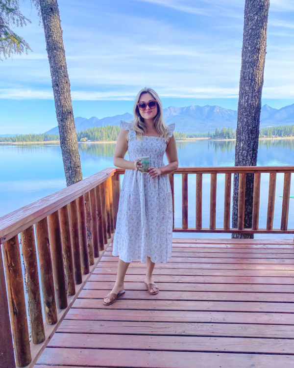 Fashion and travel blogger Jessica Sturdy wearing a Hill House Ellie Nap Dress in Pastel Trellis at a VRBO Lakefront Cabin in Montana