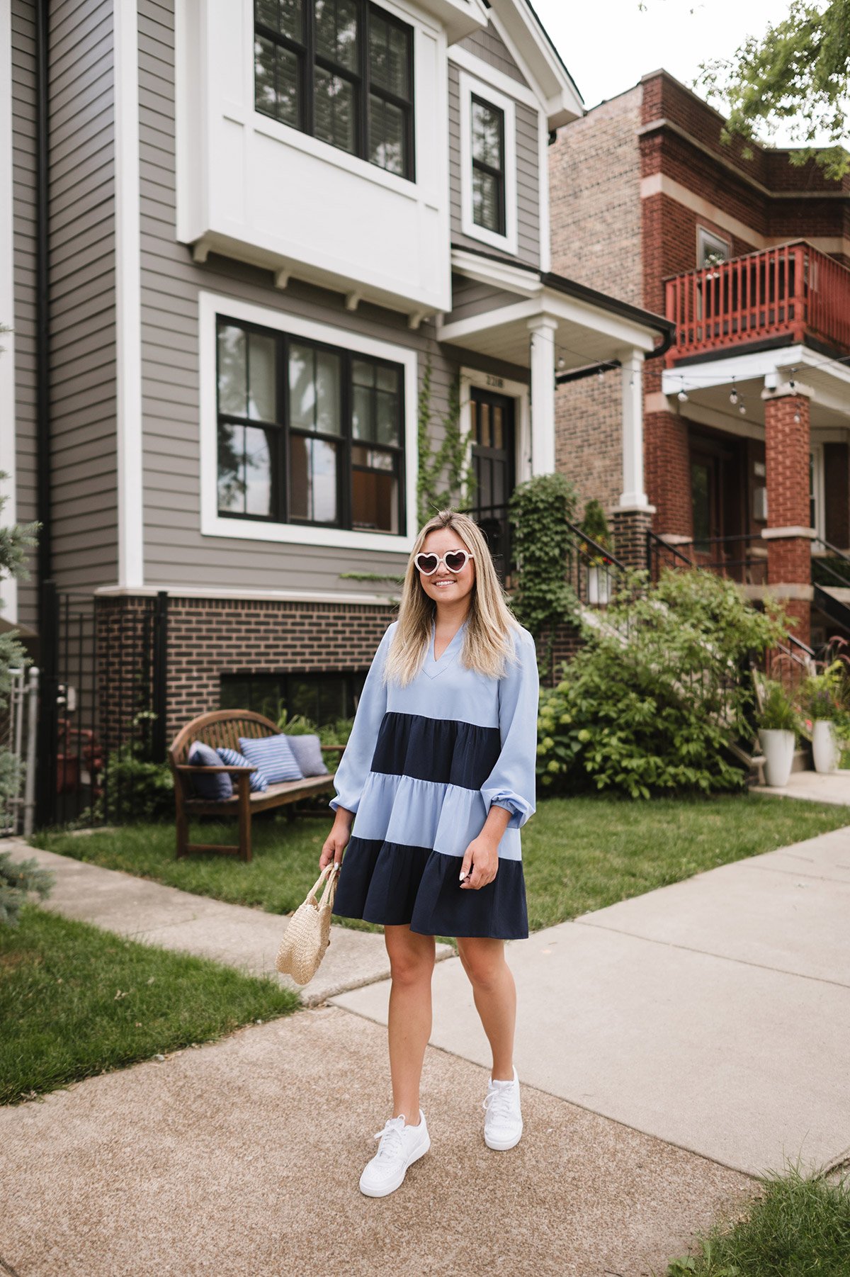 Jessica Sturdy wearing a color blocked preppy dress by Sail to Sable (from the Style Charade Capsule Collection) with white Nike Sneakers and heart shaped sunglasses by Lele Sadoughi.