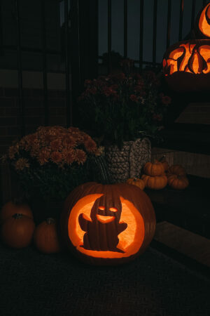 Fashion, home, & lifestyle blogger Jessica Sturdy of Bows & Sequins shares her porch pumpkins with pumpkin carving ideas, like this friendly ghost.