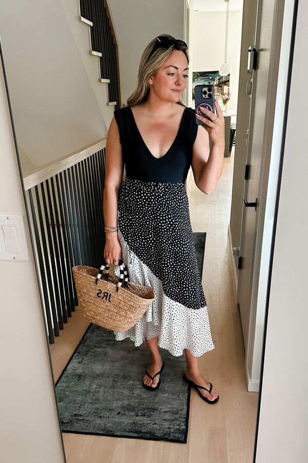 Chicago influencer Bows & Sequins styling a black one piece swimsuit with a wrap skirt from Summersalt.