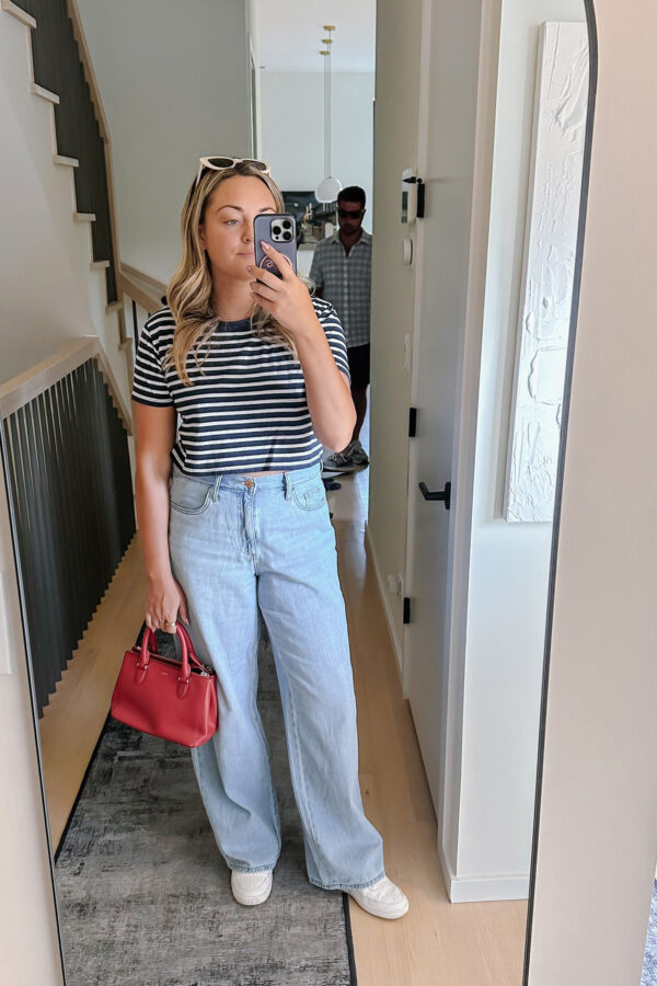 Chicago influencer Bows & Sequins styling wide leg jeans, Nike sneakers, and a cropped tee.