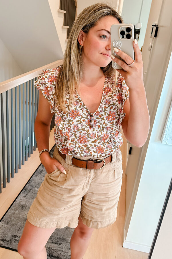 Chicago influencer Bows & Sequins styling a flutter top from Veronica Beard with linen shorts.