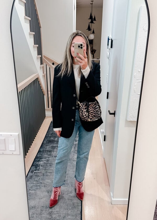 Chicago blogger styling an oversized black blazer from Everyone with a white cashmere sweater, pink velvet booties, and a Ganni leopard crossbody bag.