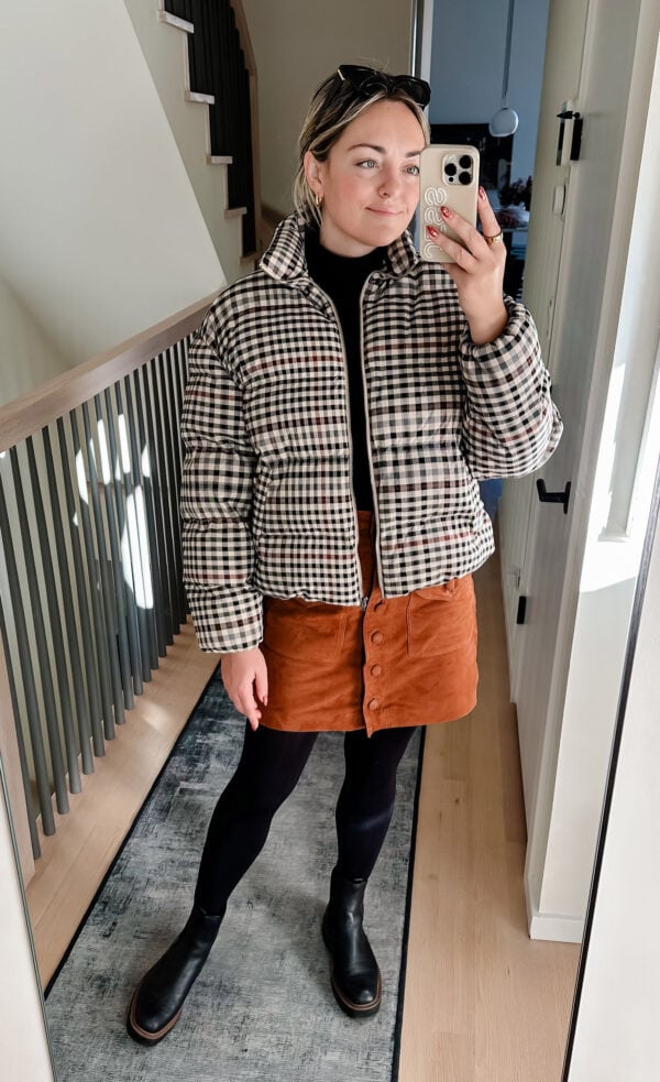 Chicago fashion blogger styling a plaid puffer jacket with a cognac suede skirt and lug sole boots.