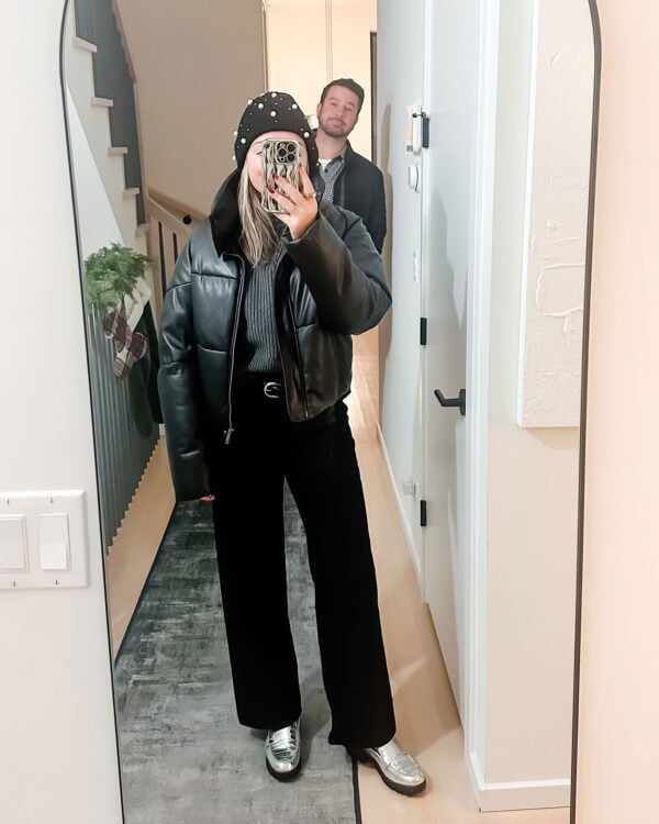 Chicago style blogger wearing an Apparis Cropped Faux Leather Puffer Coat, black jeans, a pearl beanie, and silver loafers.