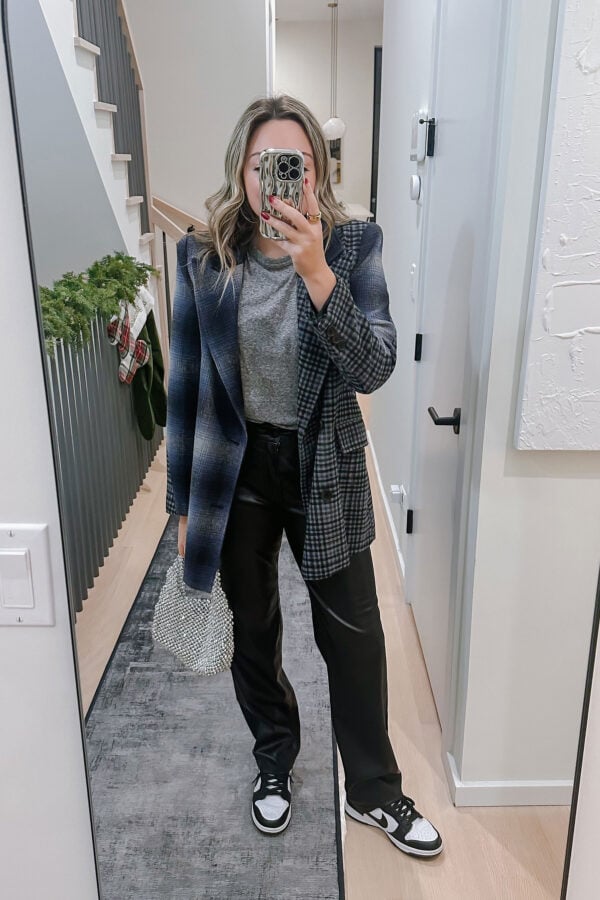Chicago style blogger Jessica Sturdy wearing a mixed plaid blazer, faux leather pants, a sparkly silver bag, and Nike low Panda Dunks.