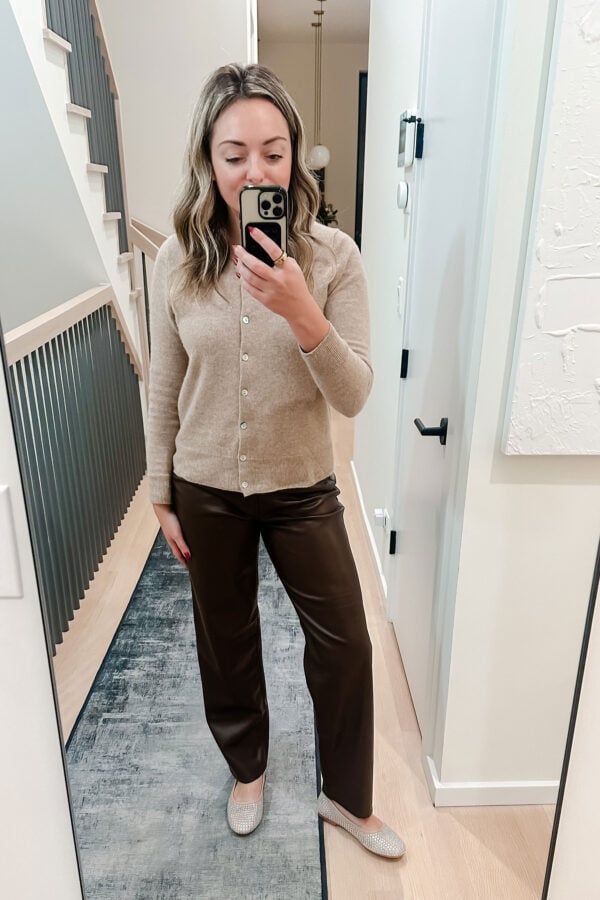 Chicago blogger wearing Quince cashmere cardigan, Old Navy chocolate brown faux leather pants, and rhinestone-covered ballet flats.
