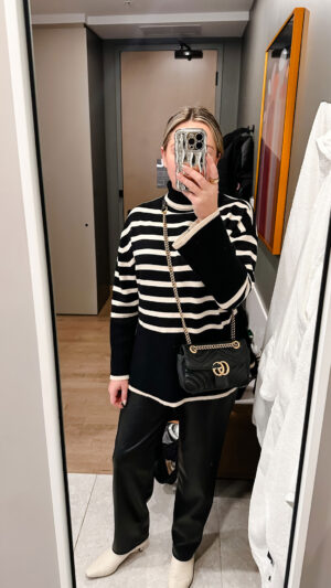 Travel blogger dinner outfit in Montreal, Canada: Amazon's Toteme Sweater Dupe Black and White Striped Turtleneck, Faux Leather Pants, Gucci Marmont Bag, and cream colored boots by Sam Edelman