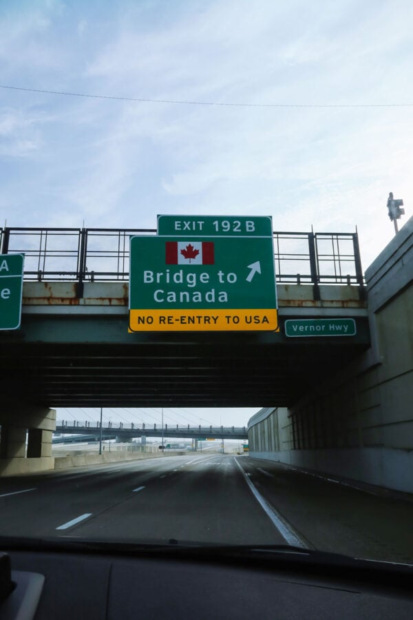 Travel blogger road trip to Canada from Chicago. Bridge into Canada from USA near Windsor.
