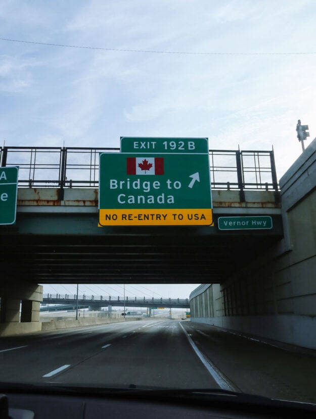 Travel blogger road trip to Canada from Chicago. Bridge into Canada from USA near Windsor.