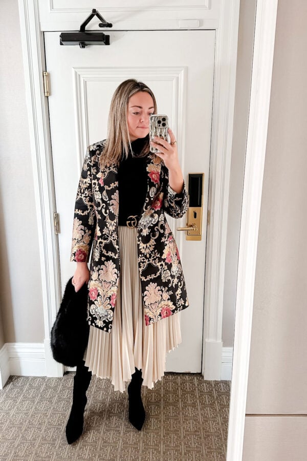 Hermoza tuxedo dress worn as a coat for a fancy hotel brunch. Black turtleneck, cream pleated skirt, sock booties, Gucci belt, and faux fur bag.