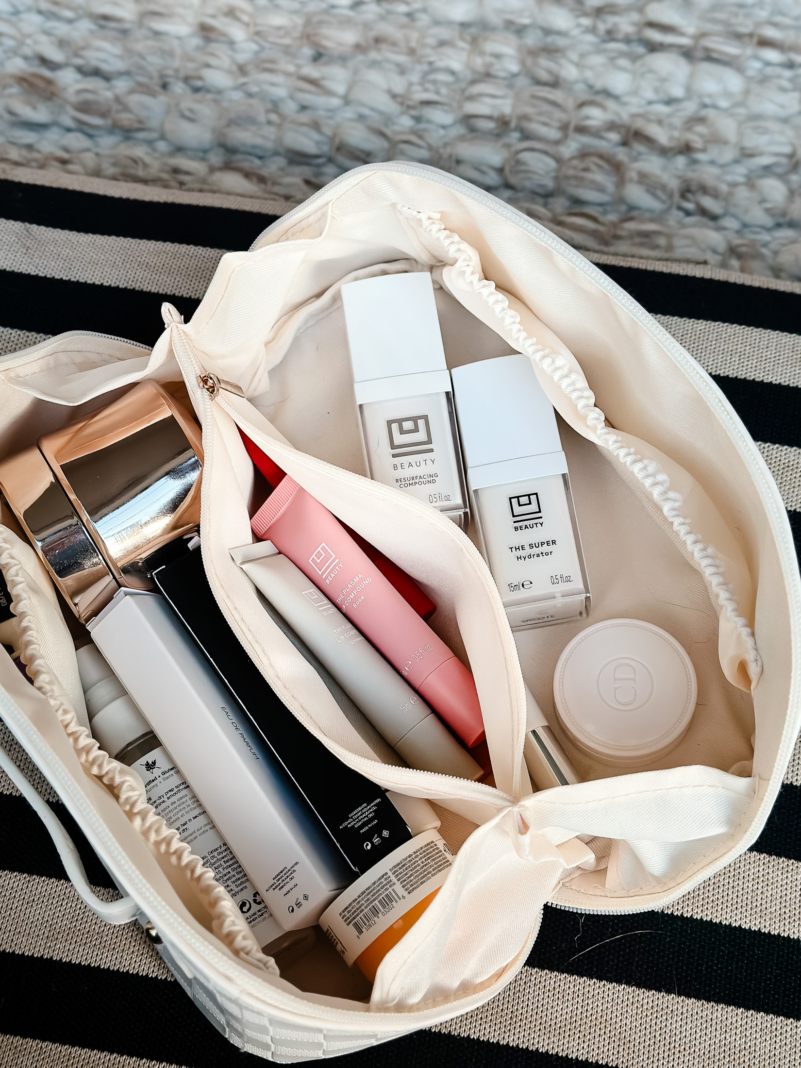 Travel toiletry bag with U Beauty skincare products inside